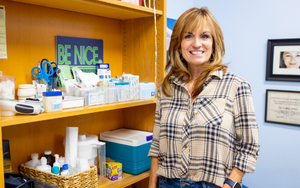  School nurse in front of supplies